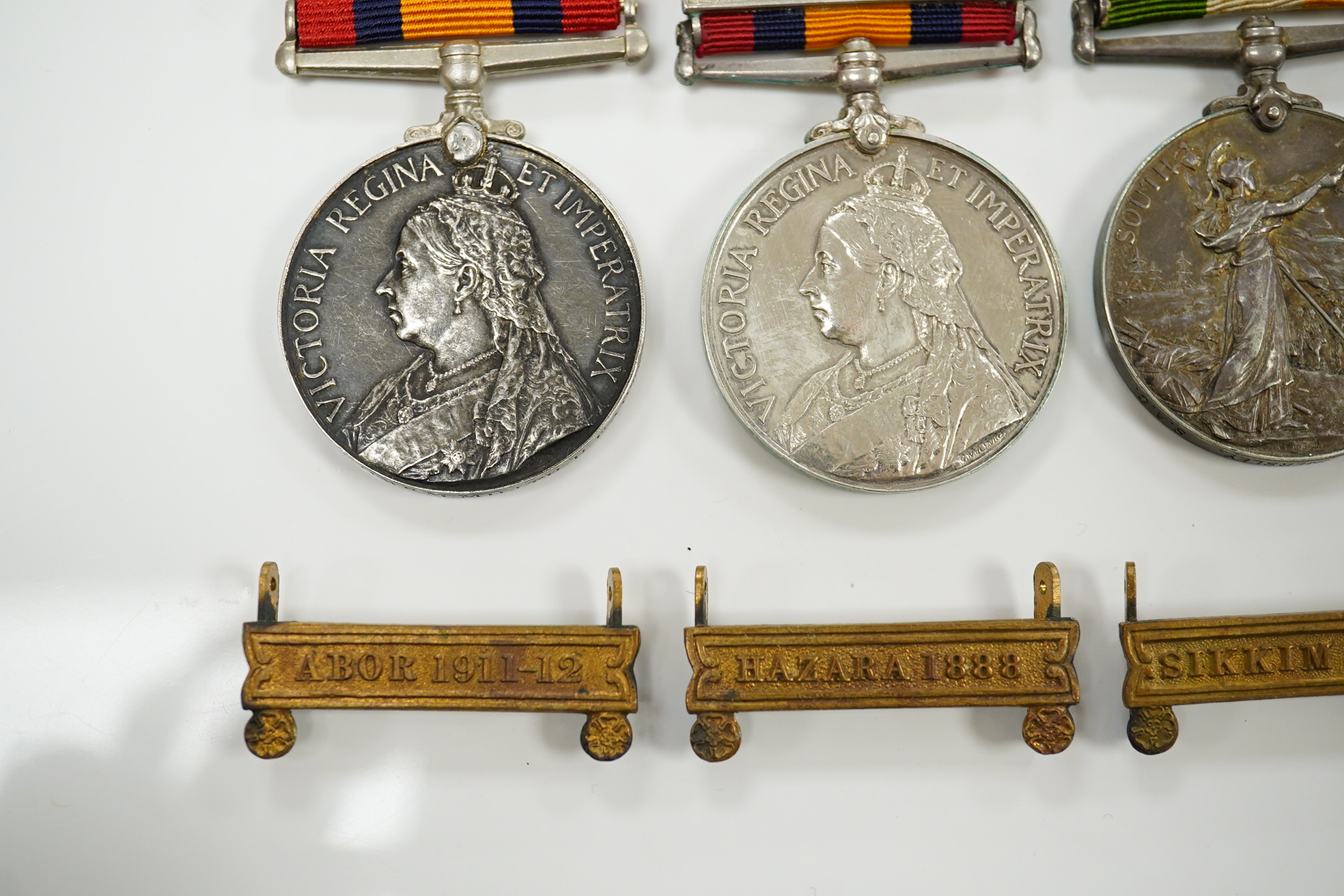 A Queen's South Africa Medal with Laings Nek, Belfast and OFS clasps to 12036 Bomr M.Miller R.F.A.Arty, another unnamed with 1901, 1902 and CC clasps, and two King's South Africa medals both with 1901/1902 clasps to 6408